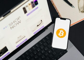 A smartphone displaying cryptocurrency graphics and the USDC logo on a digital screen.
