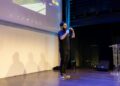 Alex Mashinsky speaking at a fintech conference, highlighting crypto regulation issues.