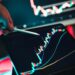 A person analyzing stock market data on a computer screen with crypto and oil price graphs.