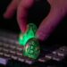 Digital illustration showing a hacker exploiting cryptocurrency systems, with money symbols.