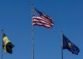 Wisconsin state flag next to symbols of prediction markets and gambling regulations.