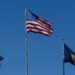 Wisconsin state flag next to symbols of prediction markets and gambling regulations.