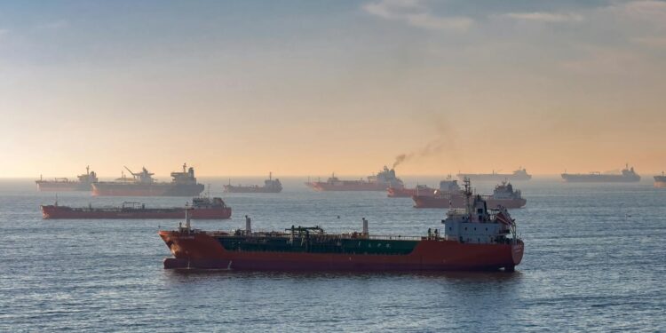 Oil tankers navigating the Strait of Hormuz with a backdrop of oil price charts.