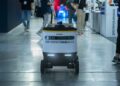Alibaba team showcasing the new AI model Qwen 3.6-Max-Preview at a tech conference.