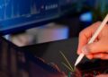 A financial analyst examining Bitcoin trends with declining charts in the background.