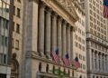 Traders look concerned at the New York Stock Exchange as markets drop significantly.