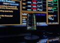 User interface displaying smart cashtags and live trading features on an iPhone screen.