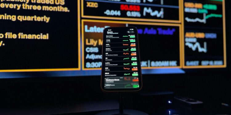 User interface displaying smart cashtags and live trading features on an iPhone screen.