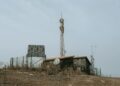 Bitcoin mining equipment with solar panels in a remote area, symbolizing off-grid technology.