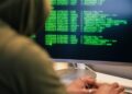 A hacker working on a computer, symbolizing the KelpDAO hack linked to Lazarus Group.