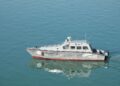 US Navy ships patrolling the Strait of Hormuz amidst heightened tensions and regulatory changes.