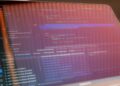 A computer screen displays code, hinting at tech controversy in Alibaba's Qwen Code shutdown.
