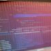 A computer screen displays code, hinting at tech controversy in Alibaba's Qwen Code shutdown.