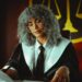 Federal judge in courtroom reviewing legal documents on cryptocurrency regulation case.