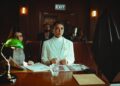 A courtroom scene with a judge, defendant, and lawyers discussing cryptocurrency fraud case.