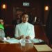 A courtroom scene with a judge, defendant, and lawyers discussing cryptocurrency fraud case.