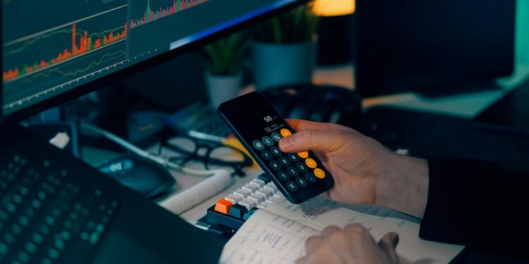 A financial professional reviewing cryptocurrency regulations with stablecoin graphics on a screen.