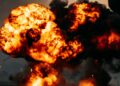 Flames erupt from a damaged oil pipeline, with smoke rising against a darkened sky.