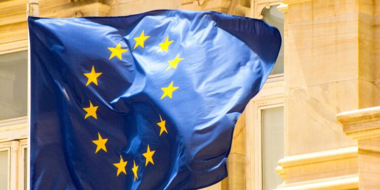 European Parliament building with EU flags, symbolizing regulatory challenges for Malta's iGaming.