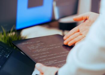 Developers collaborating on coding decentralized AI applications with blockchain elements.