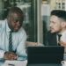 Two business professionals discussing stablecoin technology at a modern office.