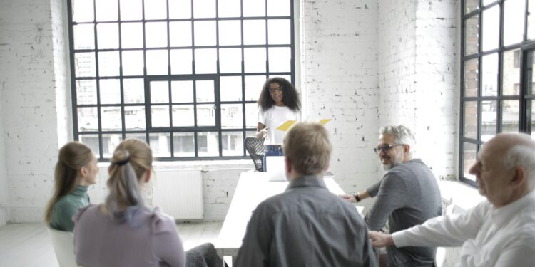 Group of diverse finance leaders discussing blockchain technology in a conference room.