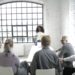 Group of diverse finance leaders discussing blockchain technology in a conference room.
