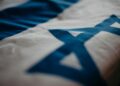 A digital representation of the Israeli flag alongside Solana's logo and cryptocurrency symbols.