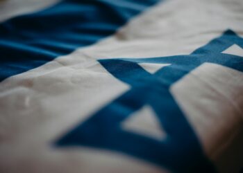 A digital representation of the Israeli flag alongside Solana's logo and cryptocurrency symbols.