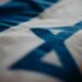 A digital representation of the Israeli flag alongside Solana's logo and cryptocurrency symbols.