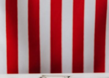 Digital currency symbols overlaying U.S. flag with cash and Republican campaign materials.
