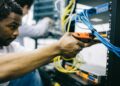 Technician repairing server in a data center during ChatGPT service disruption.