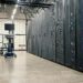 A digital rendering of a modern data center filled with AI server racks and circuitry.