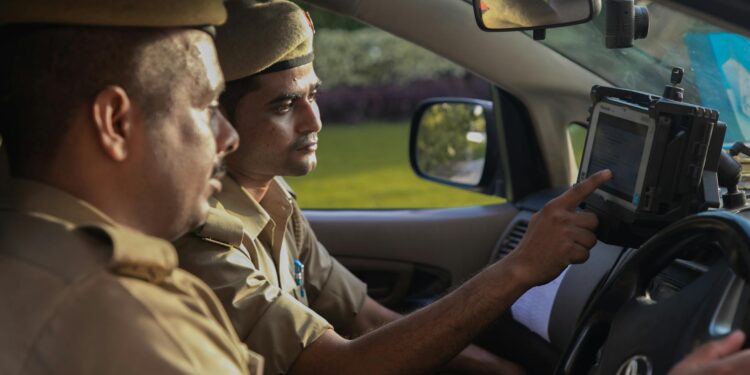Police officers conducting an operation with cryptocurrency-related documents and seized devices.