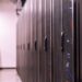 Aerial view of a large data center with servers and cooling systems, showcasing tech infrastructure.