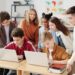 Students in a classroom setting engage with laptops during an AI training session.