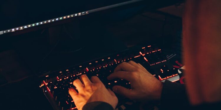 A person viewing a cybersecurity alert on a computer screen about AI theft risks.