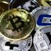 Graphic showing a crypto wallet and digital coins with a red alert symbol, indicating a security breach.
