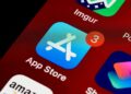 A smartphone screen displaying Bitchat app being removed from an app store interface.