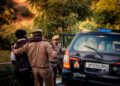 French police officers assist a distressed mother and child during a crypto ransom rescue operation.