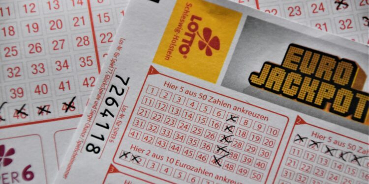 A gavel rests on a legal document surrounded by lottery tickets and gambling tokens.