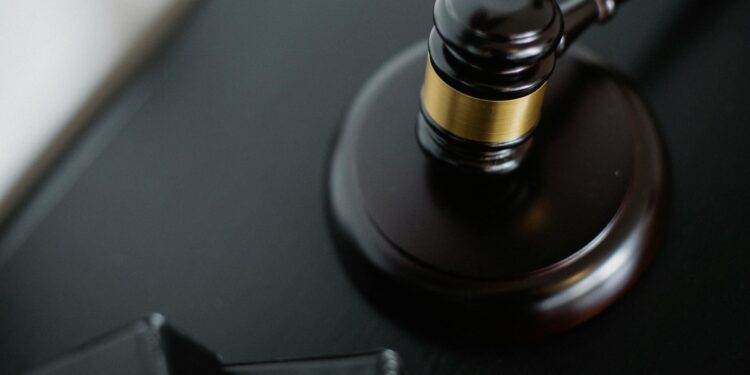 A gavel resting on financial documents, symbolizing justice in crypto fraud cases.