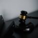 Gavel and scales representing legal action against financial regulation in New York.