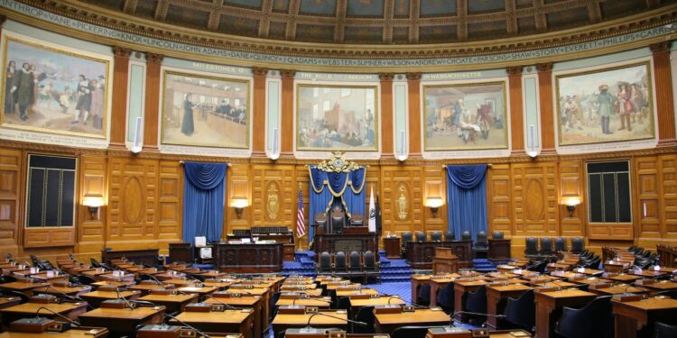 Legislators discussing AI therapy chatbot regulations in a statehouse setting.