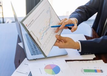 U.S. officials discuss Bitcoin reserves at a conference table with financial documents and charts.