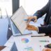 U.S. officials discuss Bitcoin reserves at a conference table with financial documents and charts.