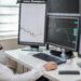 A financial analyst examines stablecoin yield graphs and data on a computer screen.