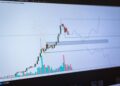 Graphs showing declining Bitcoin trading volume with concern signals in the background.