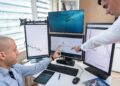 Traders monitor financial charts and screens in a bustling oil trading room.