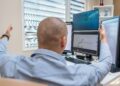 Traders monitoring stock market charts on screens reflect positive financial sentiment.